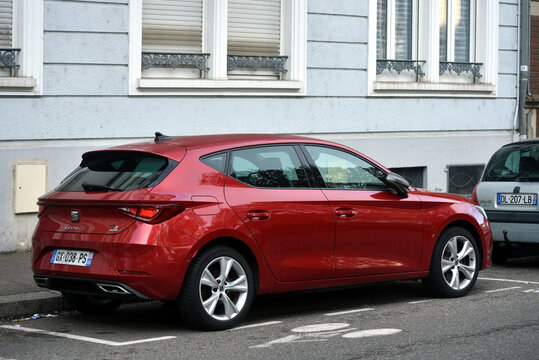 Mulhouse - France - 5 April 2026 - profile view of red Seat Leon parked in the street