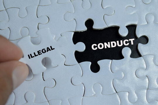 Piece of jigsaw puzzle with word illegal conduct. For identification or completion of a crime and law violation