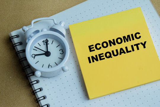 Concept of economic inequality write on sticky notes isolated on Wooden Table. For urgency and the time sensitive nature of global wealth gaps