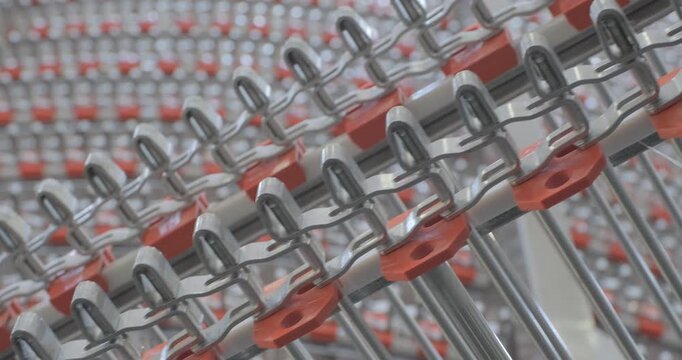 A multi-tiered spiral conveyor in operation, stainless steel mesh belts moving in different directions. A working transport system with an axisless spiral. Close-up handheld indoors shot, real time sp