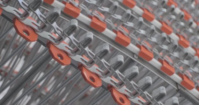 A multi-tiered spiral conveyor in operation, stainless steel mesh belts moving in different directions. A working transport system with an axisless spiral. Close-up handheld indoors shot, real time sp