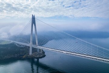Fototapeta premium Yavuz Sultan Selim Bridge in Istanbul, Turkey. 3rd bridge of Istanbul Bosphorus. Foggy weather.