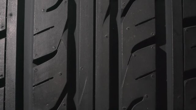Surface of a Car Tire Close Up. The surface of a car tire slowly floats in front of the camera close-up