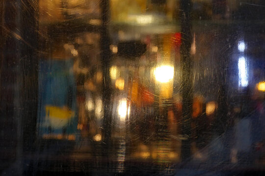 Abstract Night City Lights Through Scratched Glass &ndash; Urban Blurred Background with Bokeh