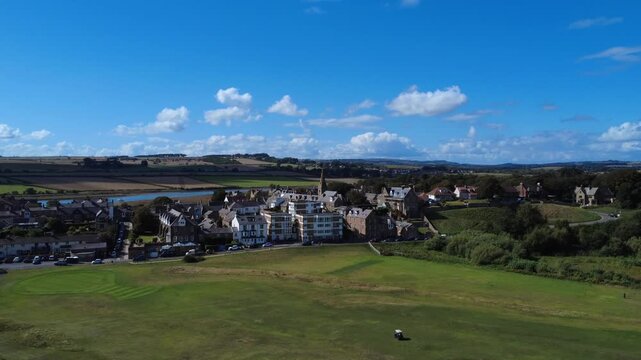 Aerial view of the village of Alnmouth in Northumberland showing buildings and roads along the river Aln and surrounding countryside