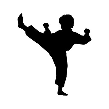 Silhouette of a child performing a high martial arts kick