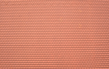 Fototapeta premium New broken Segmental beaver tail terracotta roof tiles pattern on traditional European house