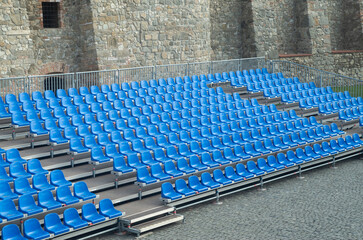 Naklejka premium Empty blue plastic seats in concert venue in rows , abstract repeating pattern