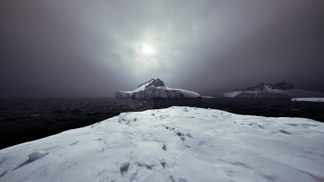 Prominent iceberg in foreground over dark sea, distant peaks on horizon, subdued sun behind veil, tactile ice textures, cinematic isolation.