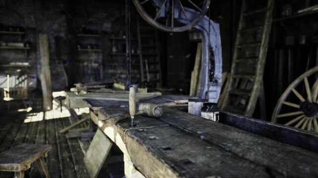Interior of historic wheelwright workshop showing large wooden wheel and lathe, tools arranged on benches. Atmosphere of traditional craft, scattered shavings