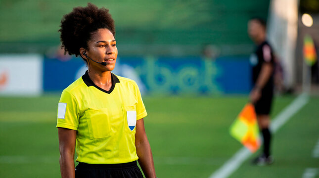 Attentive referee communicating decision during soccer match