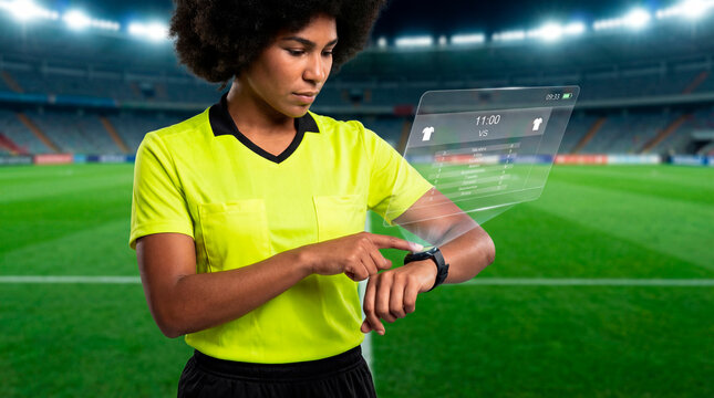 Professional referee checking match data on wearable device