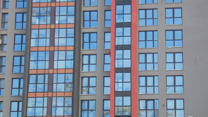 Fototapeta premium Building with multiple windows in an urban area during daytime with clear skies