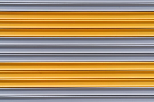 Yellow and Gray Metal Roller Shutter Door Abstract Industrial Background