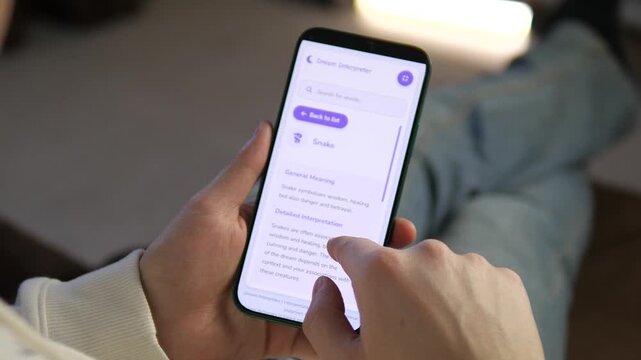 Transform your digital storytelling with this close-up of a mobile dream analysis app. Featuring clean design and smooth scrolling through symbolic meanings. Ideal for health, wellness, and tech
