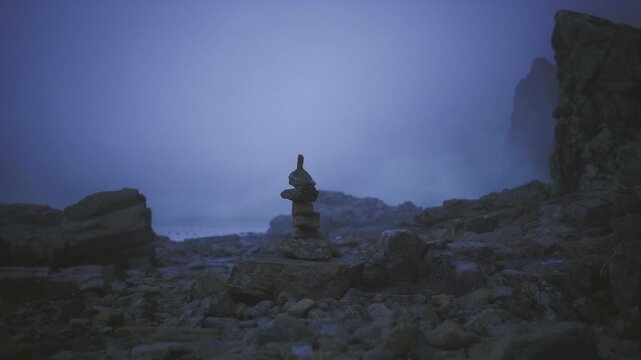 Lone stone guardian on cliff edge, stacked cairn stands like watchtower against pale sky, rugged foreground and empty vista evoke protection and quiet strength