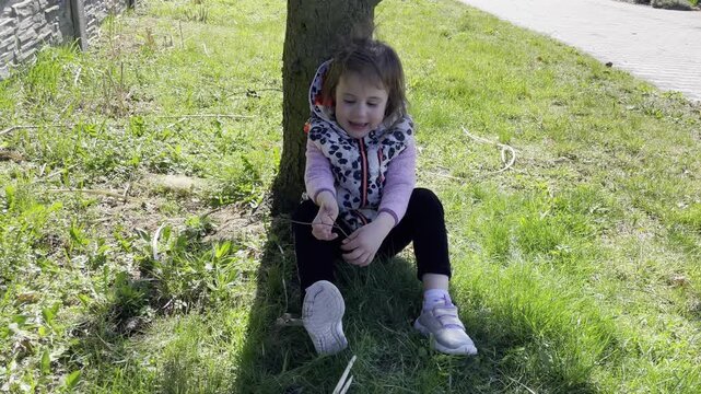 First rays of spring: toddler enjoying sunny day outdoors