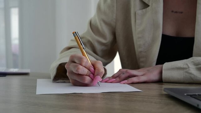 Office work.
The girl works diligently, striving to complete all assigned tasks.
She writes with a pen on a white sheet of paper, signs her name, and fills out forms.
Paperwork, filling out receipts f