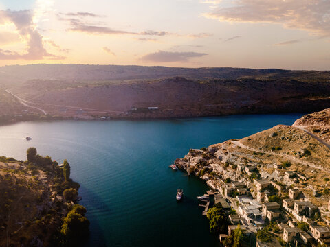 Savasan Village in Halfeti, Sanliurfa, T&uuml;rkiye, is partially submerged by the Euphrates due to the Birecik Dam, creating a striking scene of abandoned houses and rising waters.