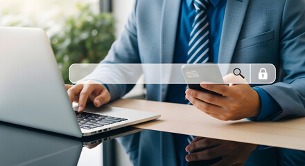 Fototapeta premium Business professional using laptop and smartphone at desk