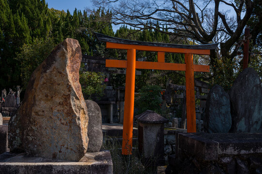 Japanese Torii Gate and Stone Monuments in Shinto Shrine Cemetery