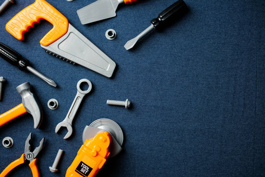 Kids toy tools on denim background with side copy space.