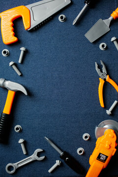 Kids toy tools frame on denim background with copy space.