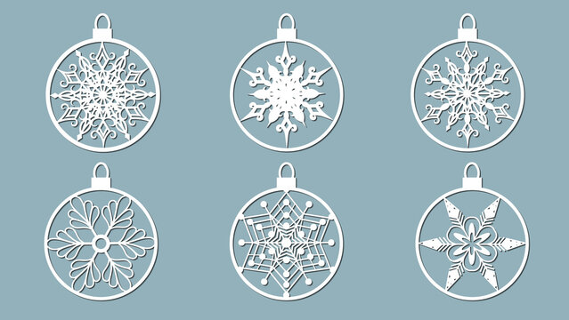 Christmas balls set with a snowflake cut out of paper. Templates for laser cutting, plotter cutting or printing. Festive background.