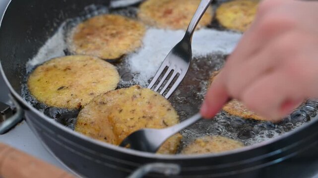 Closeup of Eggplant Wedges Frying in Hot Oil