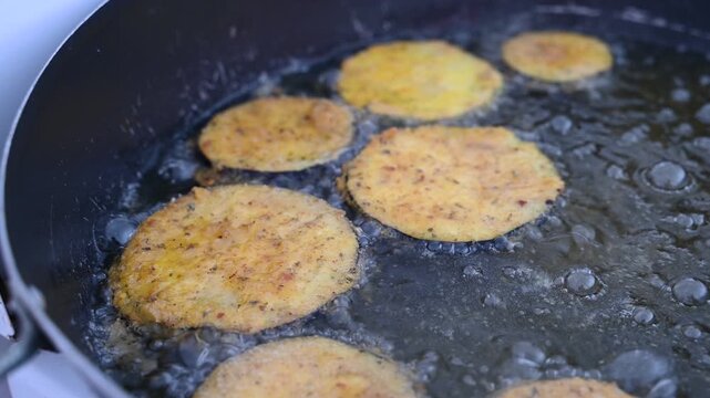Closeup of Eggplant Wedges Frying in Hot Oil
