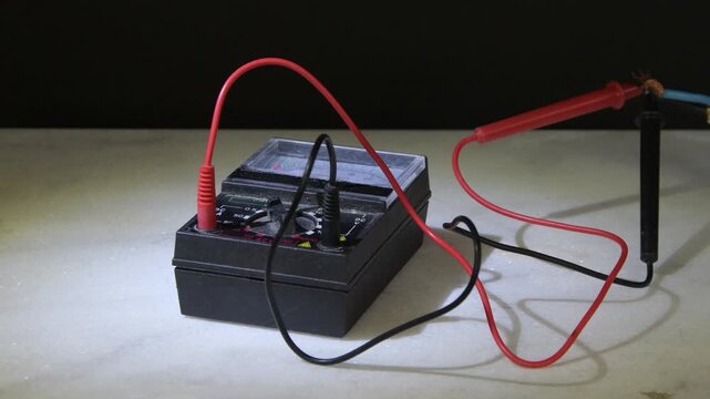 Electrical tester with wires produces sparks due to short circuit and overheating