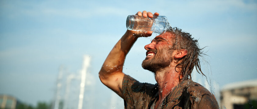 Man refreshing with water on a sunny day