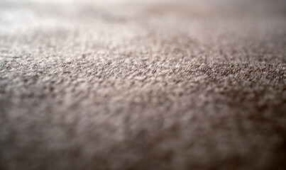 Extreme macro shot of soft brown fuzzy fabric texture with an incredibly shallow depth of field creating a highly blurred artistic background with smooth lighting © Buğra Kaan Ersoy