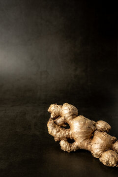 Whole ginger on a dark surface 