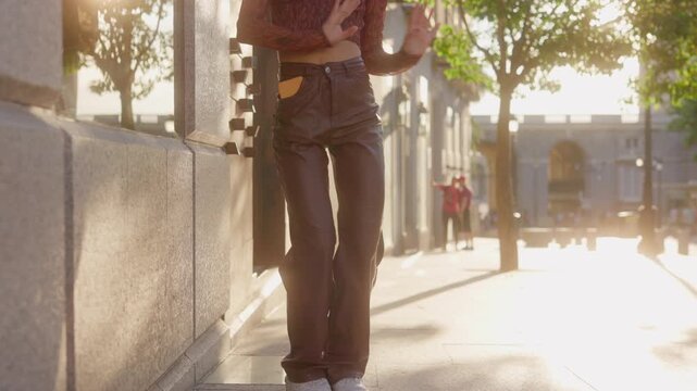 Unrecognizable Happy energetic young woman dancing on city street