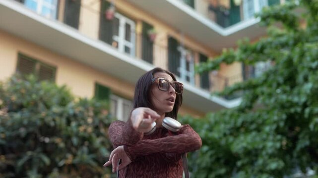Happy young female traveler dancing in a Madrid street