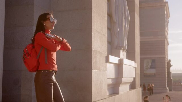 Stylish woman dancing and enjoying a sunny day in Madrid Almudena Cathedral