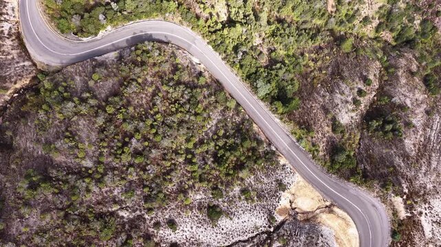 Highway traffic in mountains at Queenstown of Tasmania &ndash; aerial vertical panorama.