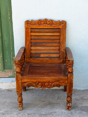 Fototapeta premium Rustic Carved Wood Chair Detail with Intricate Ornament and Vintage Style