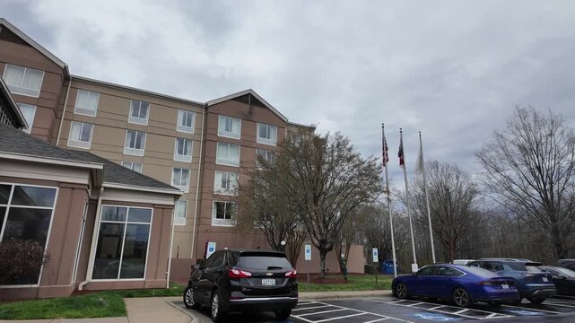Flags Are Flying Outside a Building That Has Multiple Floors