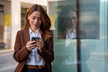 Professional woman texting on smartphone in city environment
