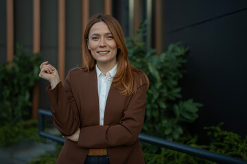 Professional woman smiling outside modern office building