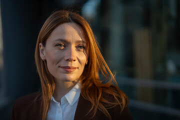 Woman smiling at sunset in urban setting