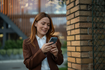 Professional woman smiling and typing on smartphone