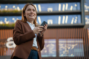 Professional woman looking up using smartphone smiling