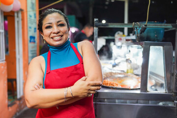 Latin woman smiling at street food taco stand © Ivan Muñoz Colorado