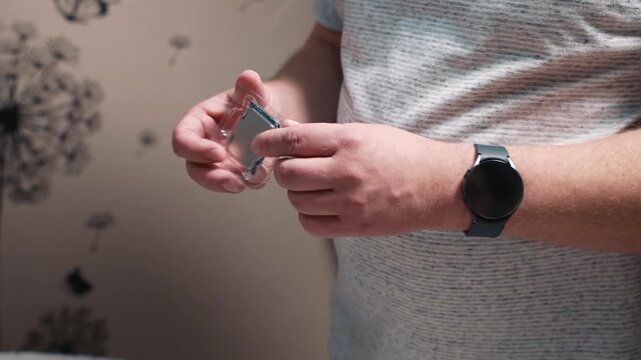 Visual inspection of processor before installation into computer, checking processor condition by hands before starting personal computer assembly on a work desk