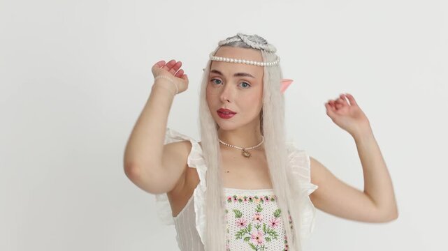 Beautiful girl dressed as elf on white background, camera moving in