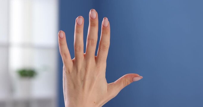 Woman counting on fingers at home, closeup
