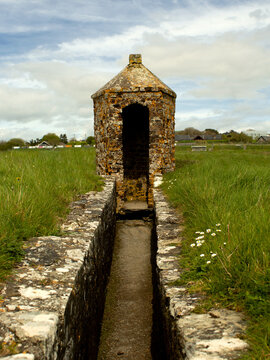 old stone lookout point in a grassy field